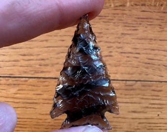 Corner-notched Elko-style dart point on banded translucent obsidian