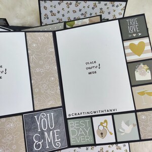 May include: A scrapbook page with a grey background and a white floral pattern. The page has a photo placeholder, a heart with a key, a dove, and the text "You & Me" and "Best Day Ever!"