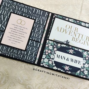 May include: A black and white scrapbook with a pink and green floral pattern. The scrapbook is open to reveal a page with the text "Our Adventure Begins" and "Man & Wife". The page also features a quote about love and marriage.