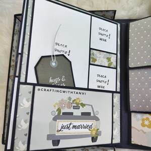 May include: A scrapbook with a green, white and grey floral pattern. The scrapbook has a black border and a white background. The scrapbook has a place to put photos and a tag that says "hugs & kisses". The scrapbook also has a car with the words "just married" on the back.