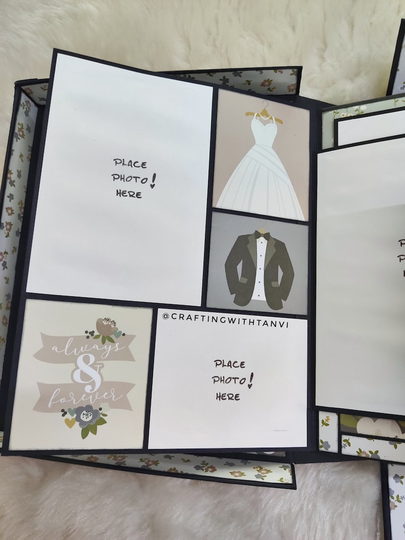 May include: A scrapbook with a black and white floral pattern on the cover. The scrapbook has a white background with black text that says "Place Photo! Here" and a black border. The scrapbook is open to reveal a page with a white background and black text that says "always & forever". The page also has a floral design with a black border. The scrapbook is closed and the cover is visible. The scrapbook is made by @CRAFTINGWITHTANVI.