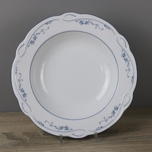 May include: White ceramic soup bowl with a blue floral design around the rim.