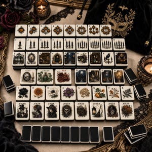 May include: A set of rectangular mahjong tiles featuring cream-colored faces with detailed illustrations of pumpkins, candles, skulls, flowers, and gothic motifs. Some tiles include text labels like SOAP, GREEN, RED, N, E, S, W, and JOKER.