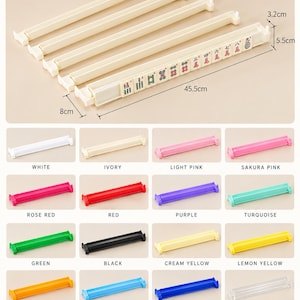 May include: A set of ivory mahjong racks with a length of 45.5 cm, a width of 8 cm, and a height of 5.5 cm. The racks are displayed in various colors including white, pink, red, purple, turquoise, green, black, yellow, blue, and clear.