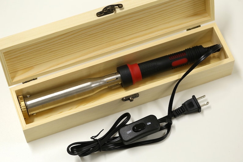 May include: A black and red electric wood burning tool with a brass tip, in a wooden box with a power cord and an on/off switch.