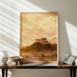 May include: A watercolor painting of a castle on a hill with a river in the foreground. The sky is a soft yellow and pink, and the castle is a light brown color.