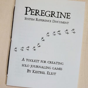 May include: A white booklet titled "Peregrine System Reference Document" with black text and bird footprint illustrations. The booklet is a toolkit for creating solo journaling games by Kestrel Eliot.