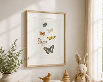 May include: A framed print featuring watercolor illustrations of various butterflies in shades of blue, orange, yellow, and black. The print hangs above a wooden dresser with a woven basket, books, a wooden bird, a stacking toy, and a stuffed bunny.