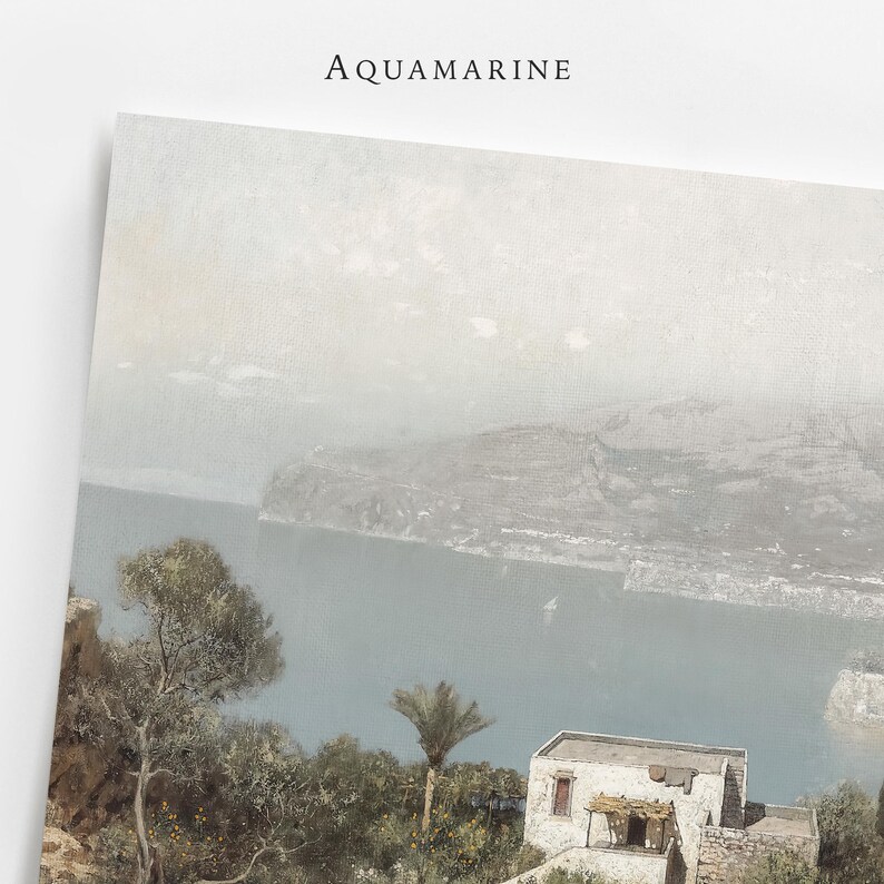 May include: A print with the word "AQUAMARINE" at the top, depicting a coastal scene with a body of water, mountains, and buildings. The artwork has a muted colour palette.