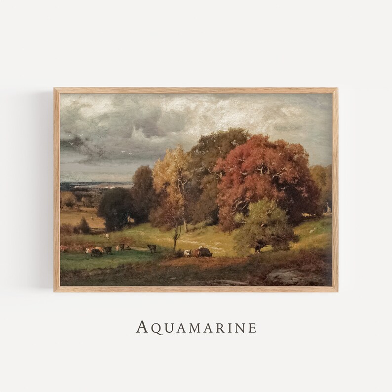 May include: A framed landscape painting featuring a pastoral scene with cows grazing in a green field. The artwork showcases trees with vibrant autumn foliage in shades of red, orange, and yellow under a cloudy sky. The word "AQUAMARINE" is printed at the bottom.