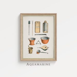 May include: A framed print featuring vintage kitchen tools in a watercolor style. The illustration includes a grater, buckets, a mortar and pestle, and a bellows. The word "AQUAMARINE" is printed at the bottom of the frame.