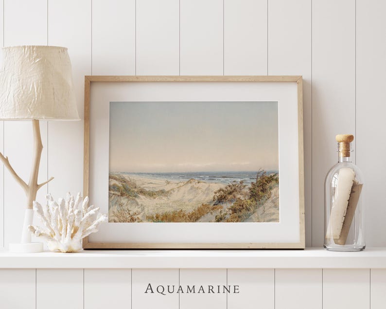 Vintage seaside landscape artwork depicting sandy dunes, coastal vegetation and gentle waves along a tranquil beach. The soft watercolor style, faded vintage tones and visible antique paper texture create a refined natural scene perfect for coastal decor, beach house interiors or classic landscape wall art.