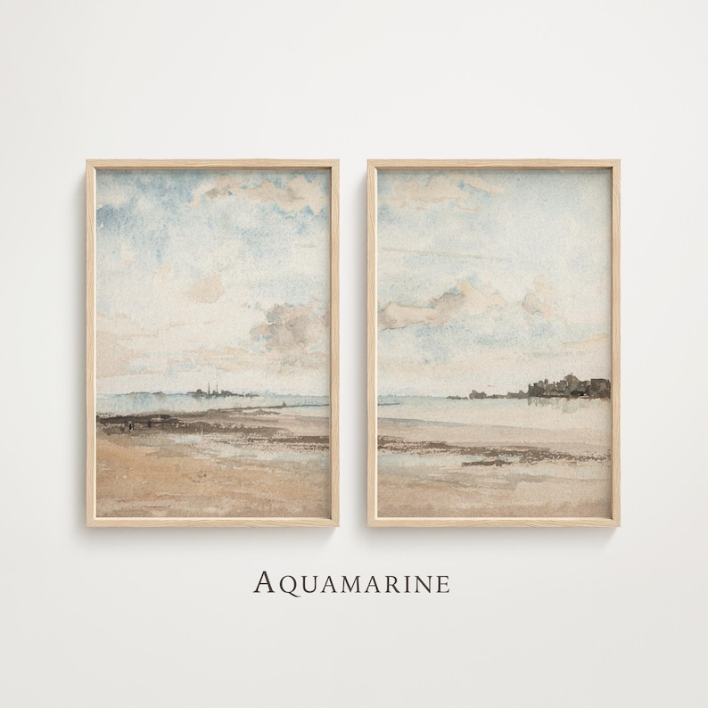 May include: Two framed watercolor prints depicting a serene coastal landscape. The artwork features a sandy beach, calm water, and a cloudy sky in shades of beige, blue, and brown. The word "AQUAMARINE" is printed in black at the bottom.