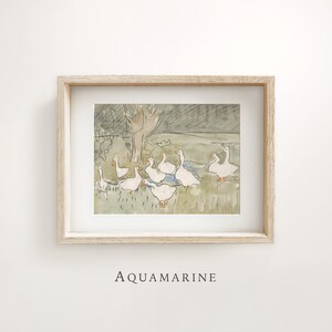 May include: Watercolor print of a flock of white geese in a grassy field, with a tree in the background. The artwork is framed in a light wood frame and includes the word "AQUAMARINE" at the bottom.