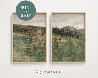 May include: Two framed landscape prints with a vintage aesthetic. The artwork depicts a field of tall grass and wildflowers in muted greens and browns, under a cloudy sky. The text "PRINT & SHIP" is on a green circle.