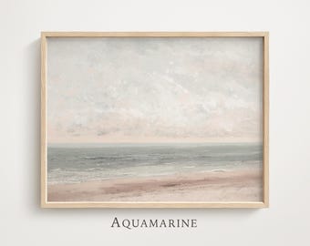 May include: A framed landscape print featuring a serene beach scene with a soft color palette. The artwork depicts a sandy beach, gentle waves, and a cloudy sky. The word "AQUAMARINE" is printed at the bottom of the frame.
