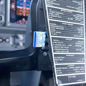 May include: A black and white checklist for pilots in a cockpit. The checklist includes items for before start, after start, before takeoff, after takeoff, descent, approach, and landing. The checklist also includes the aircraft type, 737-NG, and the aircraft registration number, 11300044-4.