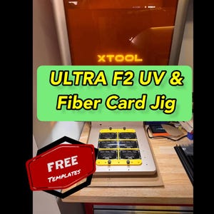 May include: An XTOOL Ultra F2 UV & Fiber Card Jig is shown in a workshop setting. The image features a yellow card jig with multiple cards, a red sign that says "FREE TEMPLATES", and the XTOOL logo.