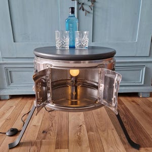 Mesa de centro, mesa auxiliar, barra hecha con tambor de lavadora.