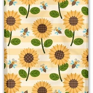 May include: A seamless pattern featuring yellow sunflowers with brown centers, green leaves, and yellow and blue bees on a yellow and white striped background.