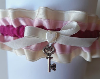 Garter for the bride made of creamy pink and pink satin