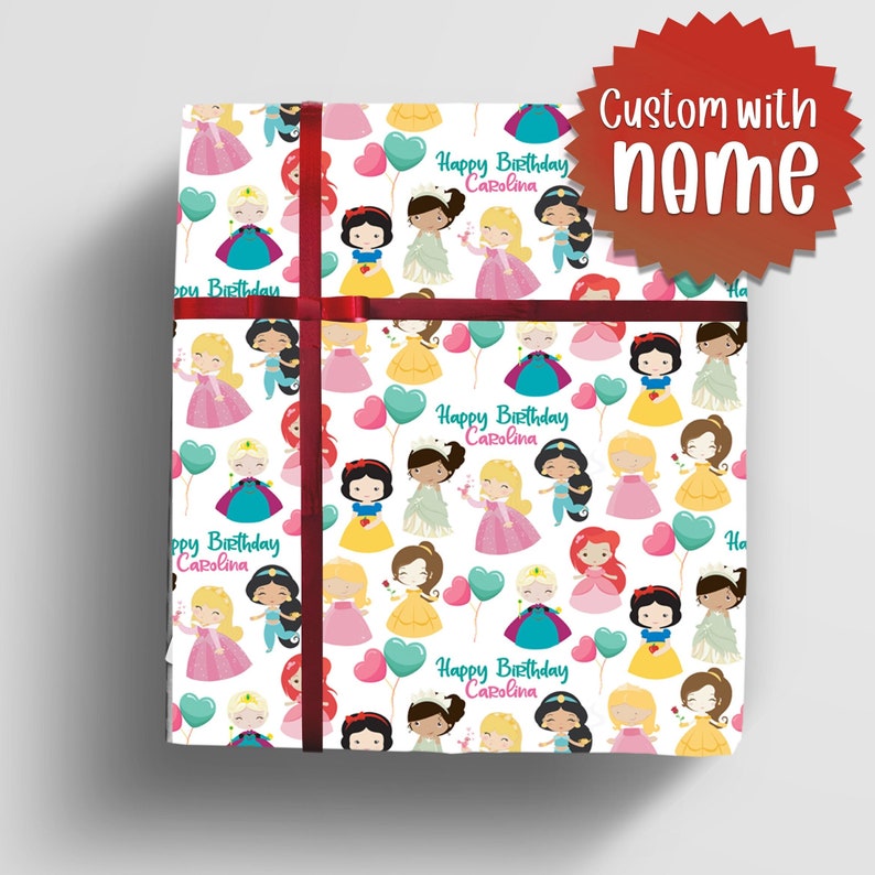 May include: White wrapping paper with a repeating pattern of Disney princesses, hearts, and balloons. The text "Happy Birthday Carolina" is repeated throughout the pattern.
