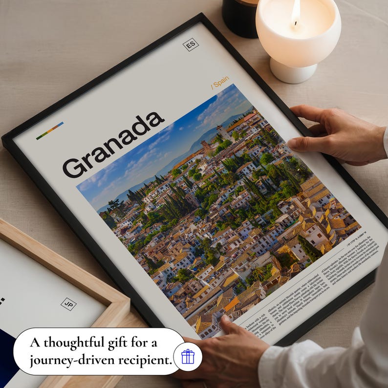 May include: A framed print featuring the word "Granada" over a scenic aerial view of a city. The print includes the text "/ Spain" and "ES" in the upper right corner. The bottom of the print reads "A thoughtful gift for a journey-driven recipient."