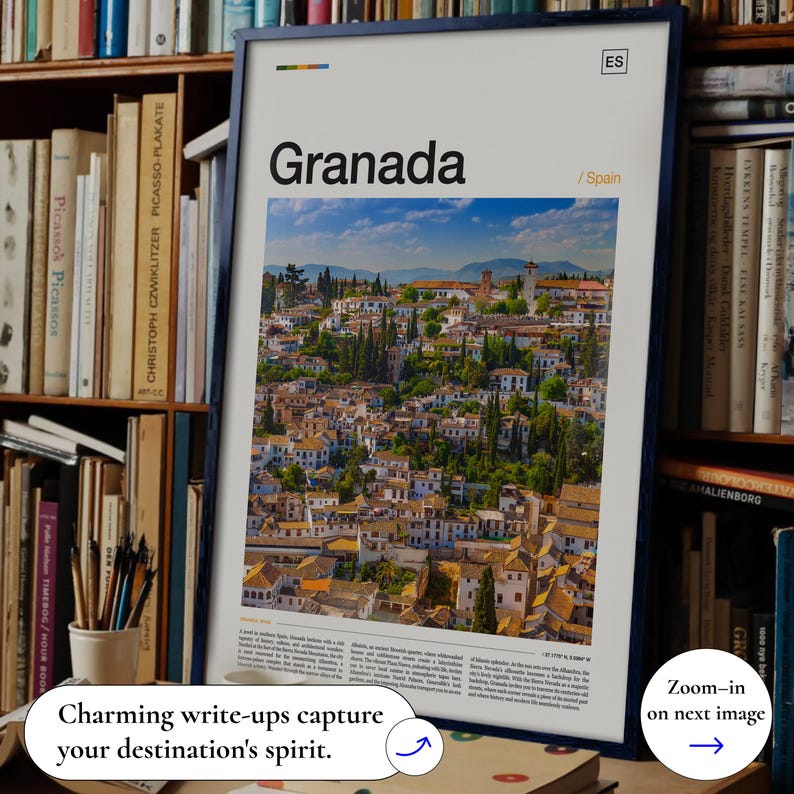 May include: A framed print featuring the word "Granada" above a scenic view of a city in Spain. The print has a blue frame and includes the text "ES" and "/Spain". The image is surrounded by bookshelves.