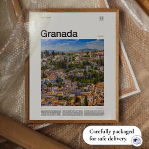 May include: A framed print featuring the word "Granada" above a vibrant image of the Spanish city. The print is in a wooden frame and includes the text "ES" and "/Spain". The bottom right corner reads "Carefully packaged for safe delivery."