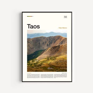 May include: A framed vertical poster featuring a photograph of the Taos, New Mexico landscape with golden mountains and blue distant peaks. The text reads Taos, New Mexico, and NM, with a small color palette bar at the top and descriptive text below.