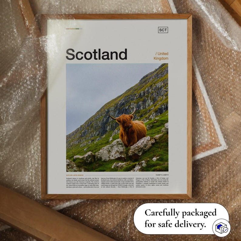 May include: A framed print featuring a Highland cow on a green hillside in Scotland. The print has the word "Scotland" in large text, with "United Kingdom" below. The print is packaged for safe delivery.
