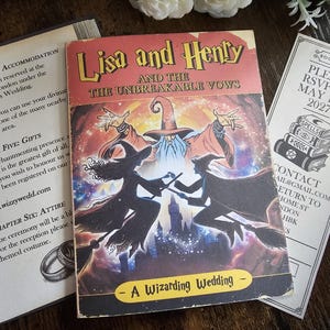 May include: A book titled "Lisa and Henty and the Unbreakable Vows" with a wizarding theme, alongside a bookmark and open book pages. The book cover features a wizard and two figures with wands. The bookmark reads "Please RSVP by May 1st 2027".