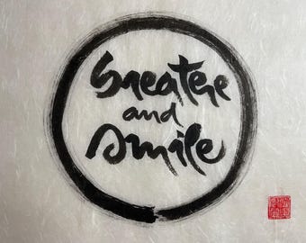 May include: Black ink calligraphy on white paper in a circle with the words "greater and smile".