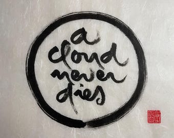 May include: Black ink calligraphy on white paper in a circle with the text "a cloud never dies".