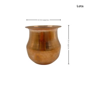 May include: A copper-coloured Lota, a traditional Indian vessel, is shown against a white background. The vessel is approximately 5 cm tall and 4.7 cm wide. The Lota has a rounded body and a flared rim.