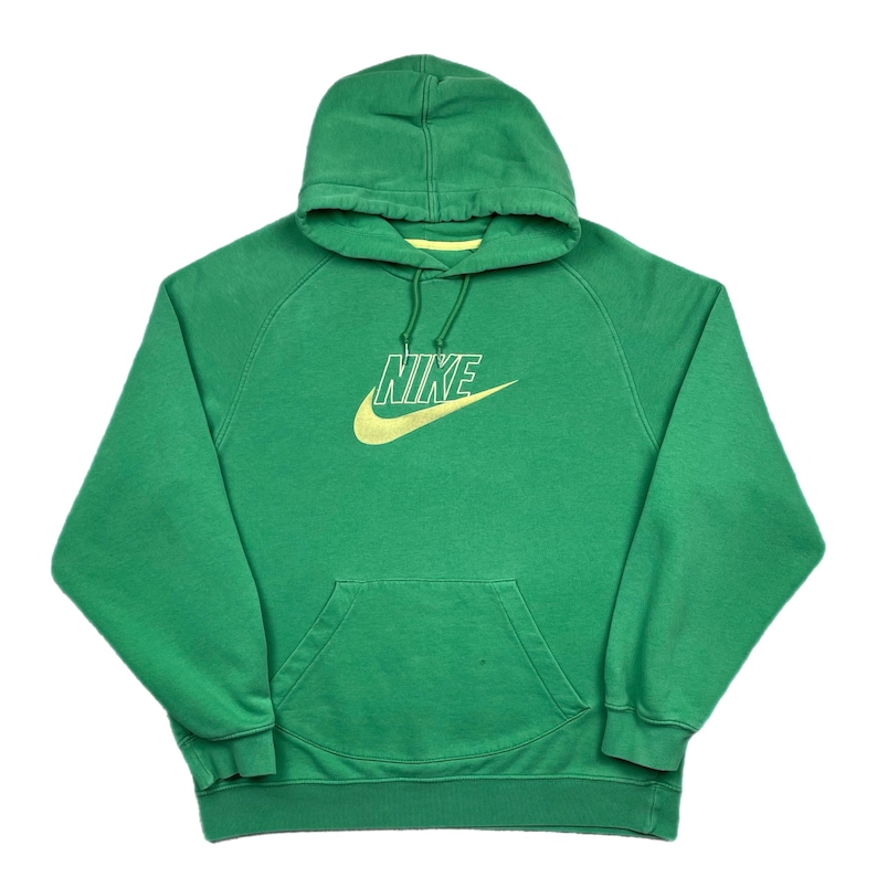 May include: Green Nike hoodie with a drawstring hood and a kangaroo pocket. The Nike logo is in yellow with a white outline. The hoodie is made of a soft material.