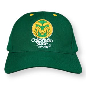May include: A green baseball cap with the Colorado State University logo embroidered on the front. The logo features a gold ram head with a white outline and the words "Colorado State University" in white.