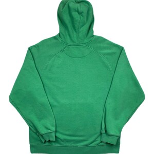 May include: A solid green hoodie with a hood and long sleeves. The sweatshirt has a ribbed hem and cuffs. The garment is made of a soft material and is suitable for casual wear. The hoodie is viewed from the back.