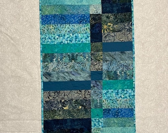 Art Quilt wall hanging. Or table topper Quilting resembles water. Free motion quilting. Blue teal turquoise binding. Table runner