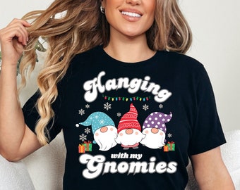 May include: Black t-shirt with a white graphic of three gnomes wearing hats and holding presents. The text "Hanging with my Gnomies" is written below the gnomes.