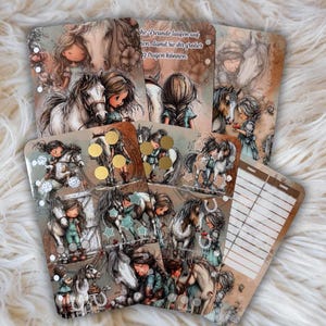 Pu&ograve; includere: Una collezione di carte illustrate con ragazze e cavalli. Le carte sono in stile acquerello, con colori tenui e disegni dettagliati. Alcune carte hanno dettagli in lamina d'oro e testo in tedesco.