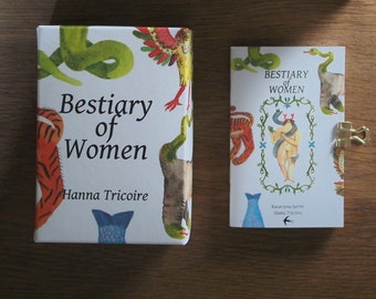 May include: A set of cards with illustrations of mythical creatures and the text "Bestiary of Women" by Hanna Tricoire. The cards are in a white box with a green and white floral design.