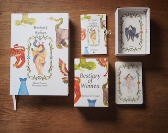 May include: A set of cards and a book titled "Bestiary of Women" by Hanna Tricoire and Katarzyna Jarosz. The cards feature illustrations of women with animal features, and the book has a similar design.