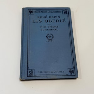 May include: A blue book with the title "Les Oberlé" by René Bazin. The book is part of Heath's Modern Language Series and is published by D.C. Heath & Company.