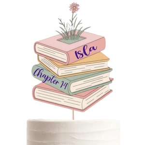 May include: A cake topper featuring a stack of four books in pastel pink, yellow, and green. The top book has a pink flower growing from it. The text "Isla" is printed on the top book, and "Chapter 14" is printed on the third book in purple.