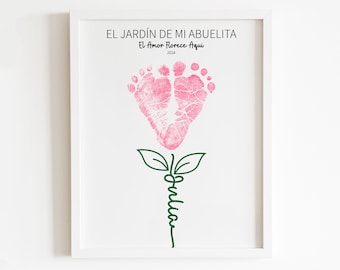 May include: A white framed print with a pink footprint flower design. The text "El Jardín de Mi Abuelita" and "El Amor Florece Aquí" is printed on the print. The year 2024 is printed below the text.