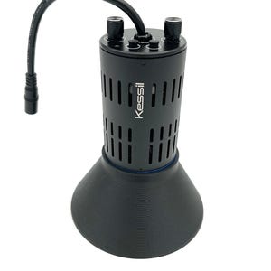 May include: A black Kessil light fixture with a round, vented body and a wide, black base. The light has two knobs on the top for adjusting settings.