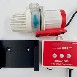May include: A red and white water pump with a black power cord and a black wall mount. The pump has a digital control panel with a dial, plus and minus buttons, and a "FEED" button. The control panel reads "DCW-1500 SINE Wave Technology" and "Jebao".