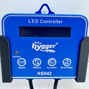 May include: Blue LED controller with a digital display and buttons for mode, frequency, light, and Wi-Fi/feed. The controller is labelled "hygger" and has the model number "HG042".