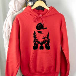 May include: Red hooded sweatshirt with a black silhouette of the Death Star from Star Wars.